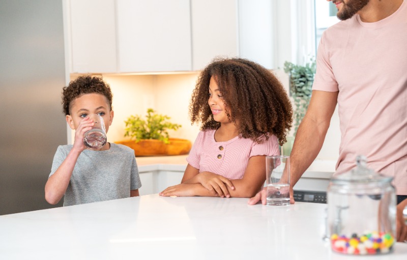 Children enjoying a glass of clean drinking water